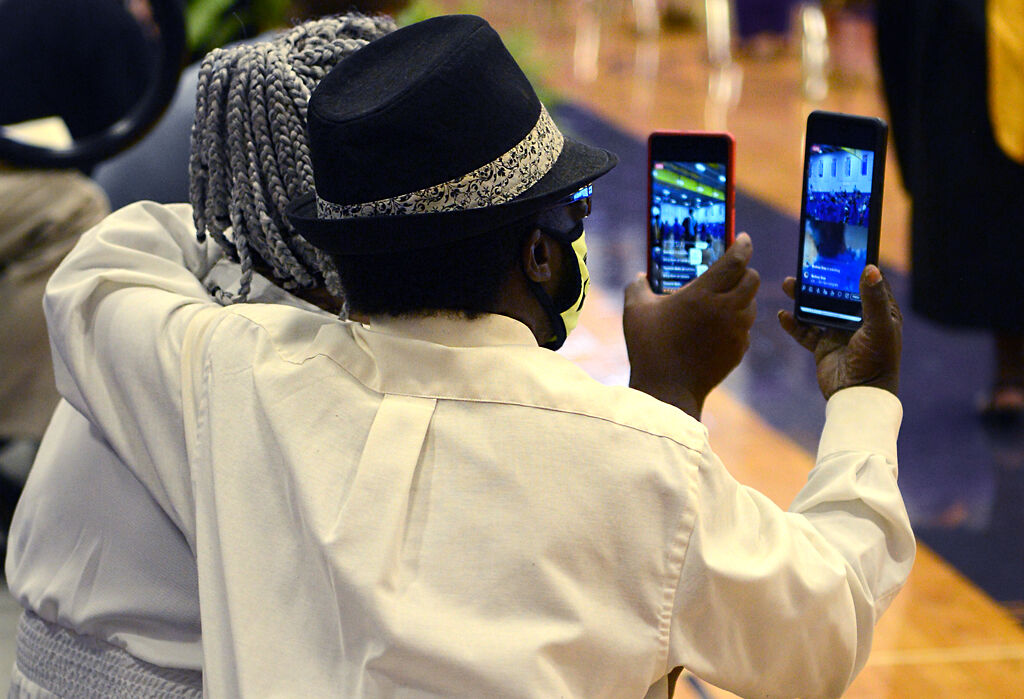Clifford Crowell and Jannie Crowell record the graduation ceremony